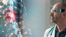 Doctor looking at holographic spinal image