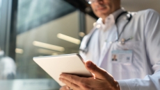 Healthcare provider looking at a tablet