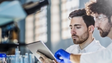 Healthcare professionals looking at tablet computer