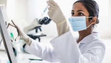 Technician analyzing the content of a test tube