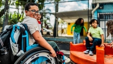 Student in a wheelchair on a playground