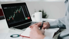 Young businessman using laptop for analyzing data stock market
