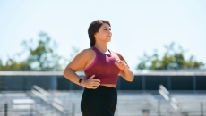 A woman working out wearing a Fitbit Inspire 2