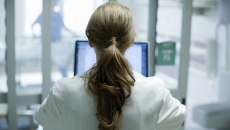 Person sitting at a computer with their back turned
