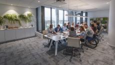 Numerous people sitting around a table