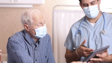 Healthcare provider and senior citizen on a tablet
