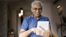 An elderly using a digital tablet