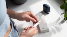 Person holds a test strip. Healum, NHS, women's health