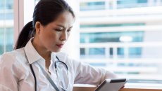 A clinician using a tablet.