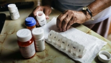 Hands and a pill organizer
