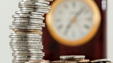 Coins and a clock on background