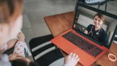 A woman talking to a provider via her laptop