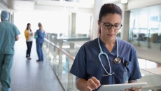 Healthcare provider looking at a tablet