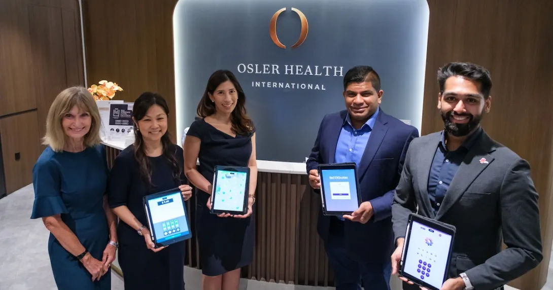 Representatives of NTU Singapore spin-off Gray Matter Solutions and Osler Group showing the application-based early dementia detection tool