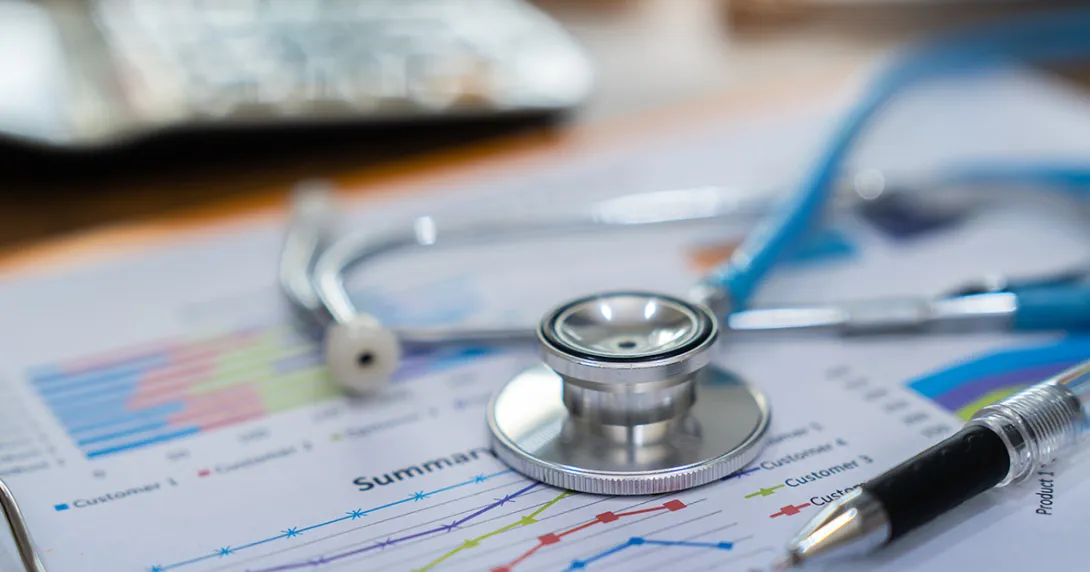 Financial report on a desk with a stethoscope on top
