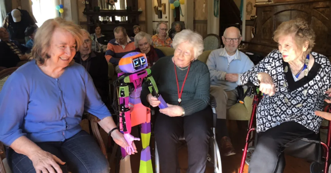 Senior residents at Allity interacting with the companion robot Abi by Andromeda Robotics