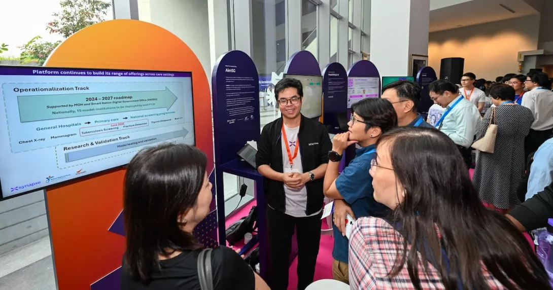 Attendees of Synapxe's first AI conference at a booth