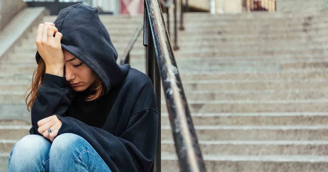 Depressed person sitting on stairs