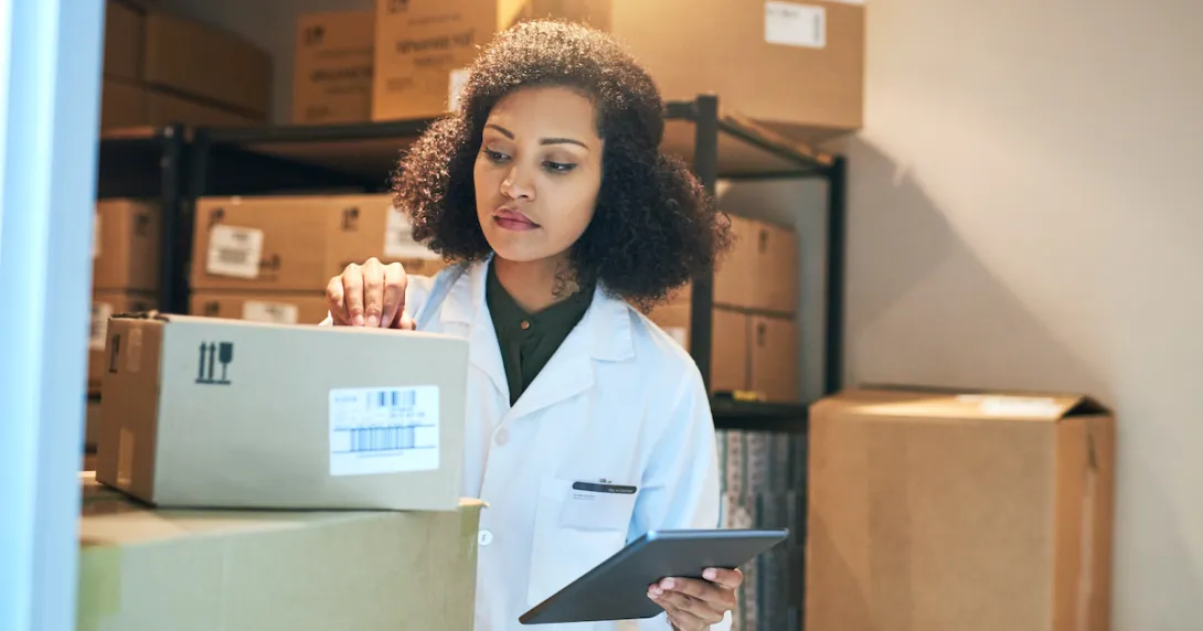 A pharmacist doing stock inventory using a digital tablet
