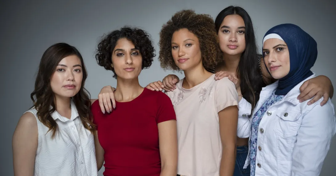 Five people standing next to each other facing the camera