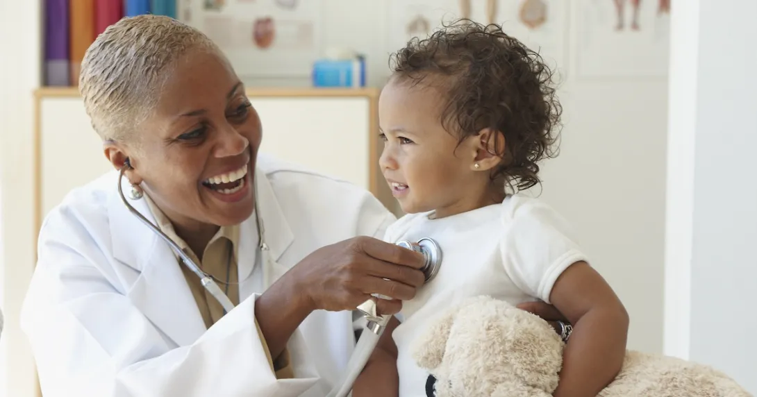 Healthcare provider checking a small patient