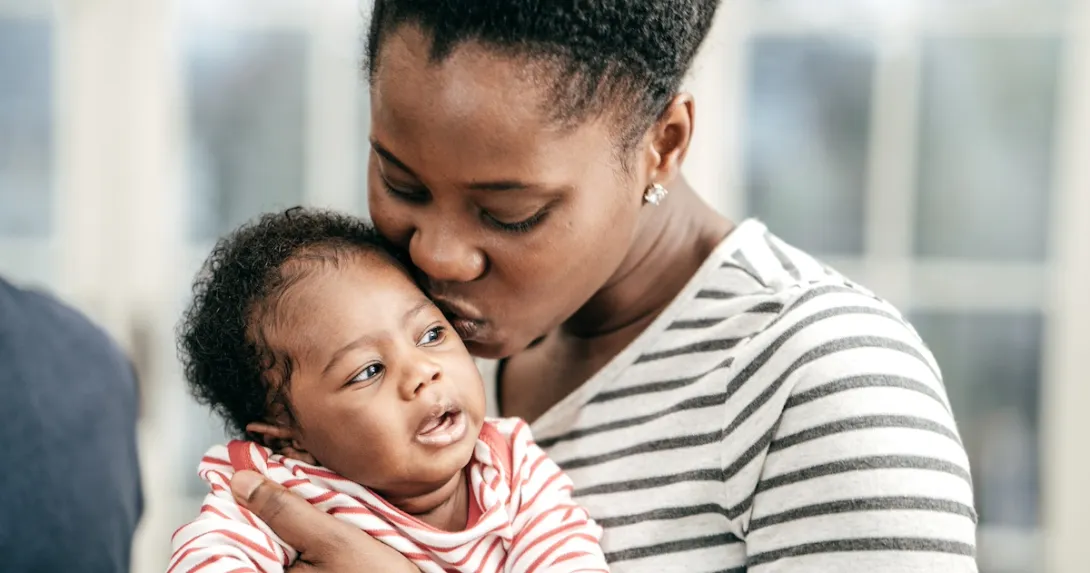 A person holds an infant
