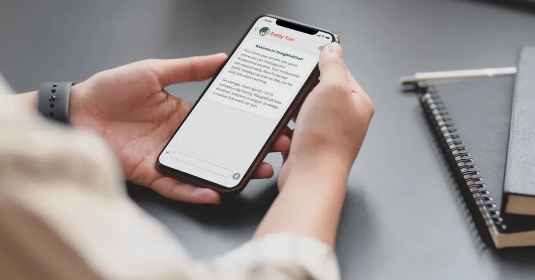 A person using the ThoughtFullChat app on a mobile phone