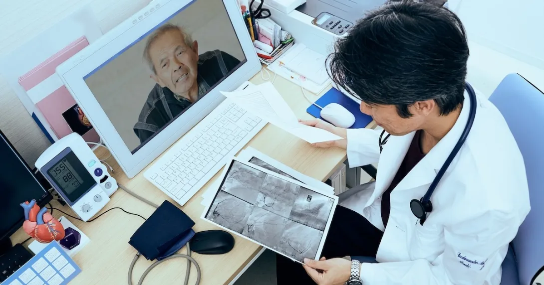 Doctor consulting with patient via computer