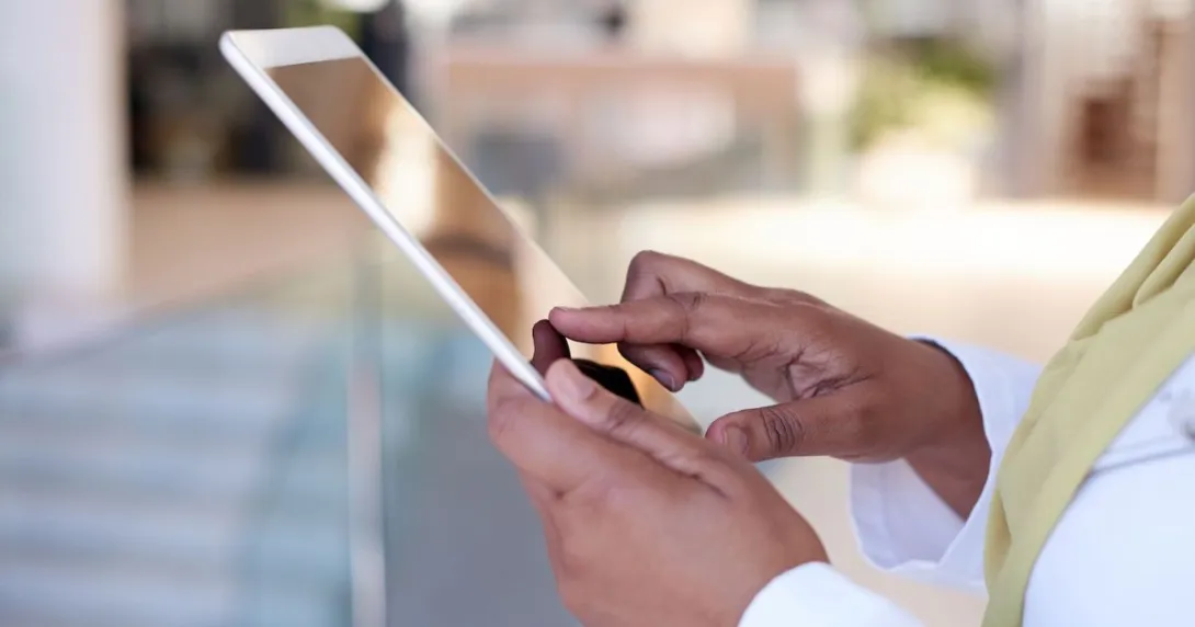 A close up photo of a woman using a tablet
