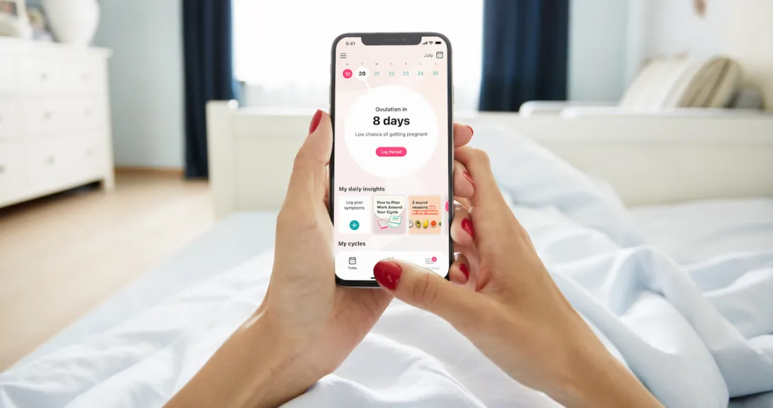 A close up of a woman using the Flo app