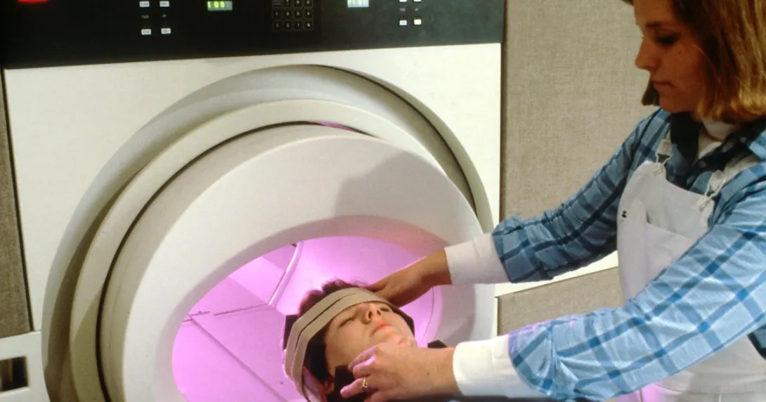 Technician prepares a patient for MRI