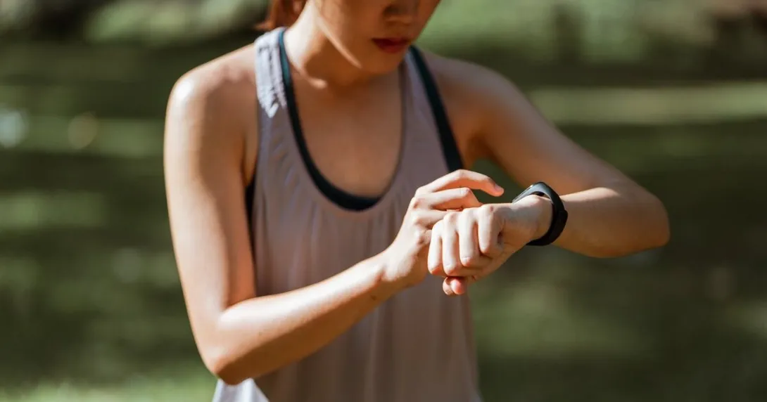 A runner checking their vital signs on their fitness tracker