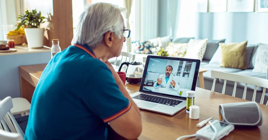 An older man talking to a provider via telehealth
