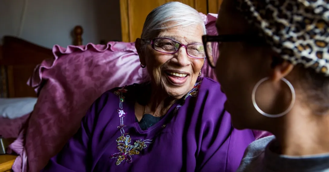 Two people looking at each other and smiling