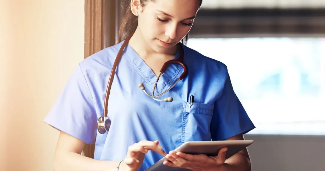 A doctor scrolling through a tablet