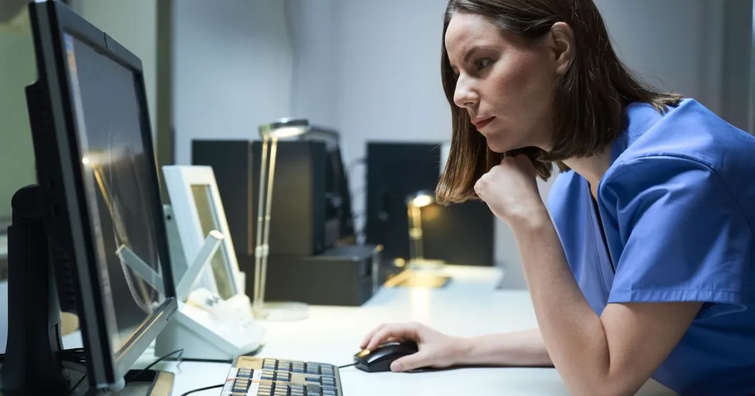 Healthcare provider sitting at a computer