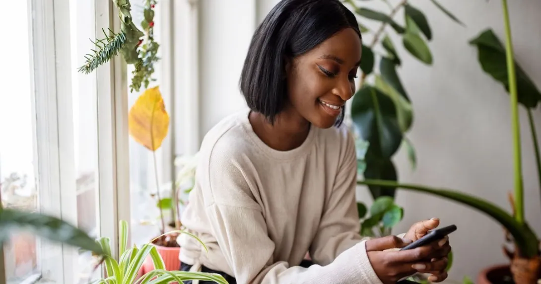 Person sitting in a chair while looking at a phone