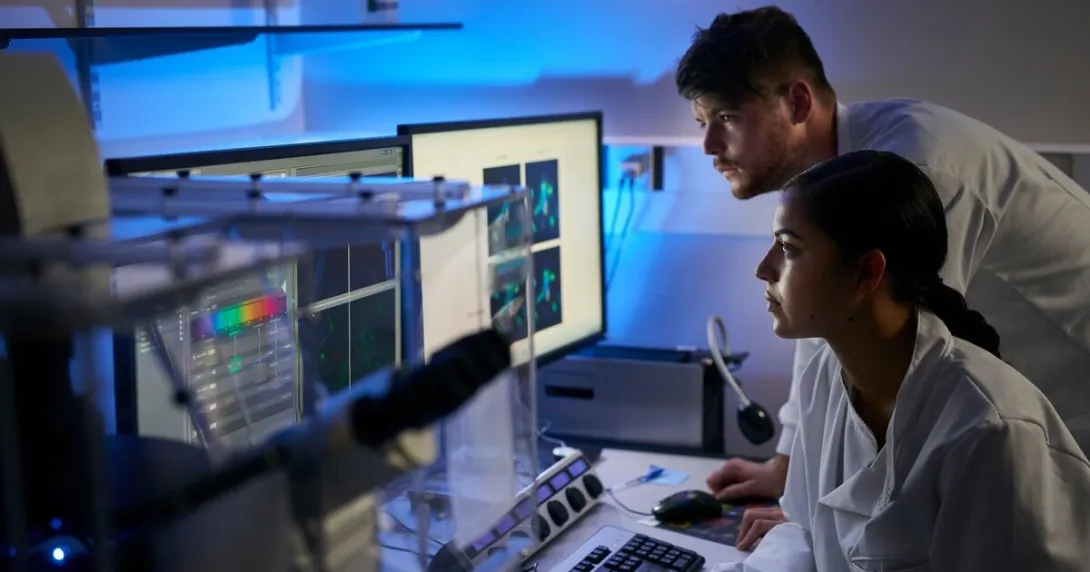 Laboratory scientists reviewing a computer-aided analysis