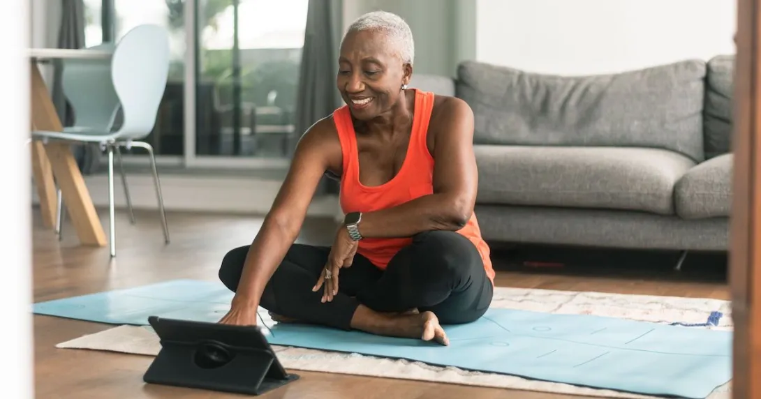 A woman exercising while using a tablet